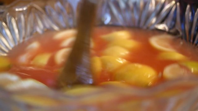 Mixing Lemons in punch bowl to make pink lemonade or kool-aid ALT