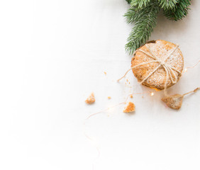 Homemade cookies on a white tablecloth,Christmas tree branches and lights