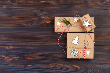 Three Festive Boxes in craf Paper Decorated with Snowflakes and star on Wooden Table. Top View