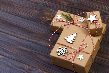 Christmas gift box decorated by snowflake on wooden background
