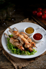 Homemade shish kebab from marinated chicken breast on wooden skewers.