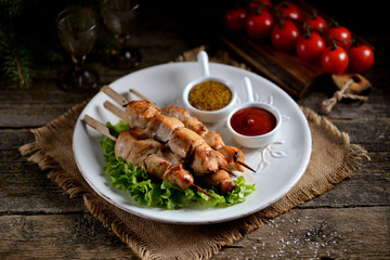 Homemade shish kebab from marinated chicken breast on wooden skewers.