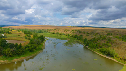 A wild natural meandering river amidst meadows and forests. The photo shows the beauty of eastern nature not destroyed by human exploitation yet.