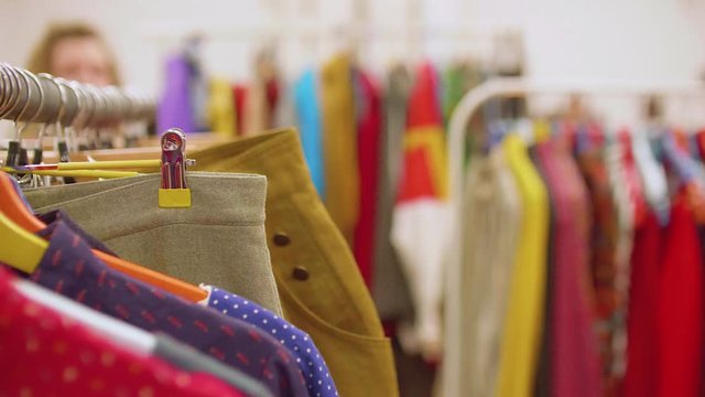 Row of dresses hanging on hangers with blur background