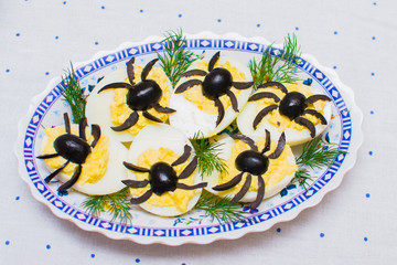 stuffed eggs decorated with olives in the form of spiders