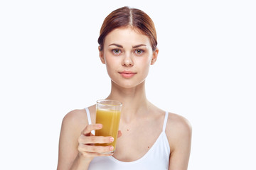 Young beautiful woman on white isolated background holds a glass of freshly squeezed juice, diet, fitness, slimming