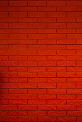 Fototapeta na wymiar wall of small red bricks vertical. stone texture