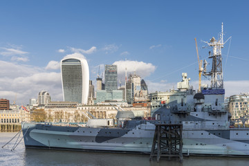 River Thames with HMS Belfast, London, UK with City of London financial district background on a sunny Autumn day