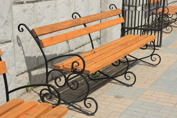 Wooden bench with wrought iron fragments