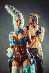 Young couple in a role playing game, girl is holding a man in the horse mask on the chain. - obrazy, fototapety, plakaty