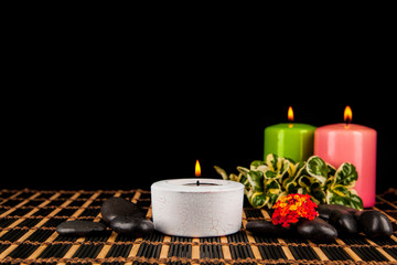Burning candles and pebbles for aromatherapy session
