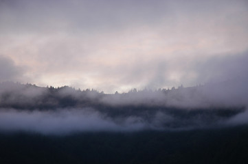 Mist over a mountain range at sunset