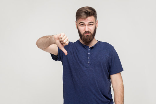 Portrait Of Unsatisfied Bearded Man With Thumbs Down