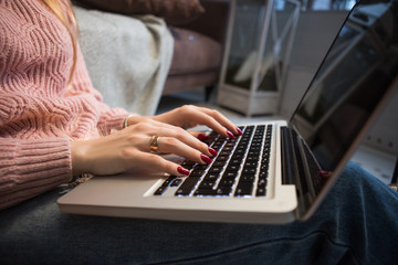 Woman working at home office hand on keyboard close up