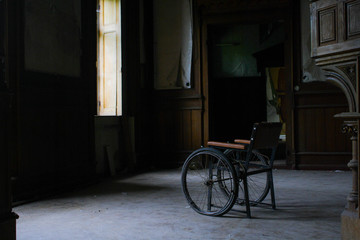 Fototapeta na wymiar Wheelchair In Abandoned House