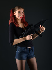 Obraz na płótnie Canvas Sexy model woman with a gun. 