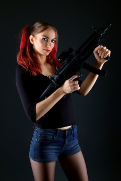 Sexy model woman with a gun. 