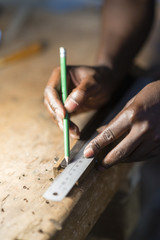 Working the wood with the hands and tools.