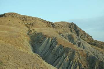 Amazing mountain terrain and the light at sunset. Mysterious Cape Meganom, Crimea.
