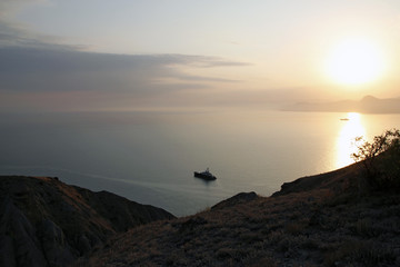 The view of the beautiful sunset with the mysterious Cape Meganom, Crimea.
