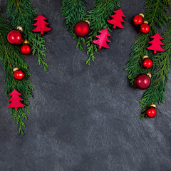 Cristmas decoration with pine branches and ornaments on a slate plate with free space for your text