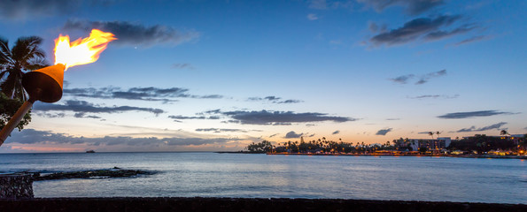 Kailua-Kona bay at sunset with a view of the pier.
