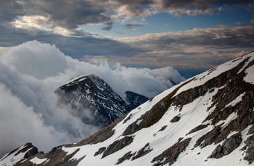 Waterfall-like low level orographic Föhnmauer clouds flowing down Karavanke Karawanken range steep...