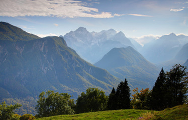Vertical walls and forests of Vrata, Kot, Sava valleys with Triglav, Jerebikovec, Rjavina peaks Julian Alps Triglav National Park, in sunny autumn morning from grassy glade of Karavanke range Slovenia © nogreenabove2k