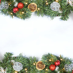 Christmas background with top view of wreath, decorations and snowy overlay