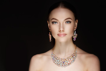 Model in set of jewellery. Luxury girl in shine jewelry from precious stones, diamonds. Beautiful...