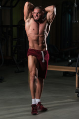 Fototapeta na wymiar Handsome Man Flexing Muscles