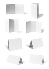 collection of various  blank folded leaflet or a desktop calendar white paper on white background. each one is shot separately
