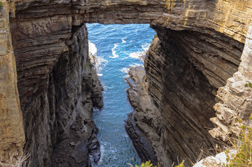 Tasman Arch has been created by the wind and waves for millions of years - Eaglehawk Neck, Tasmania, Australia