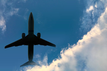 Fototapeta premium plane on a background of blue sky and white clouds.