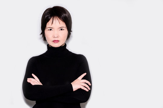 A portrait of an oriental woman wearing a black turtleneck sweater
