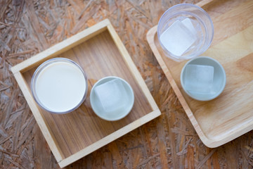 Fresh milk in wooden cup served with ice