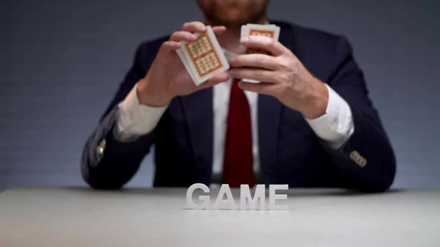 Male hands mixing card deck before handing on gambling table. Gambling card game