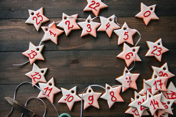 Gingerbread star cookies garland. Christmas concept. Wooden background.Toned and top view. Copy space.