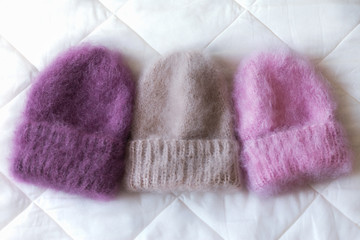 Fluffy hats of various styles and colors hand-knitted