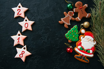 Christmas ornew year background. Different shapes of gingerbread cookies and decorations on a wooden backdrop. Copy space and top view.