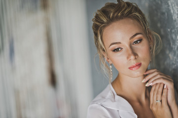 Portrait of a girl with an original hairstyle of blonde hair 124.