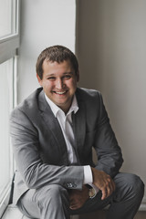 Satisfied with life male in a business suit sitting at the window 148.