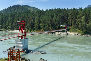 Suspension bridge over river Katun in village Barangol. Altai Republic, Russia