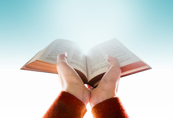 Hands of Woman Raise up a Bible for Praying