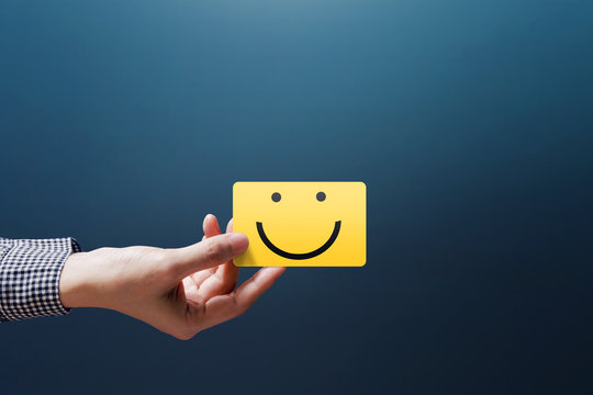 Customer Experience Concept, Happy Client Woman show a Feedback with Happy Smiley Face Card