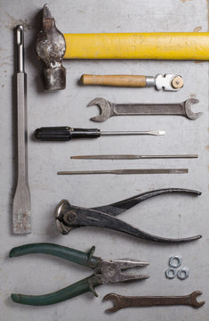 Set of hand old tools on grey background. Top view