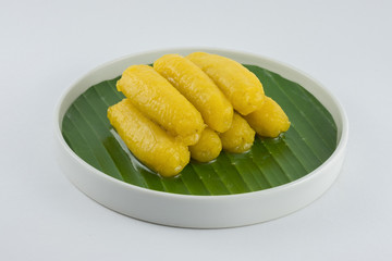 Preserved banana in syrup, Thai style, served on a white background.