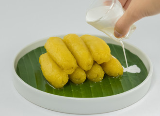 Preserved banana in syrup, Thai style, served on a white background.
