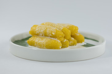 Preserved banana in syrup, Thai style, served on a white background.