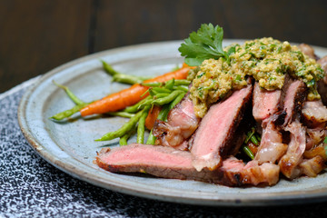 Close up Steak with Green Olive Pesto. (selective focus)